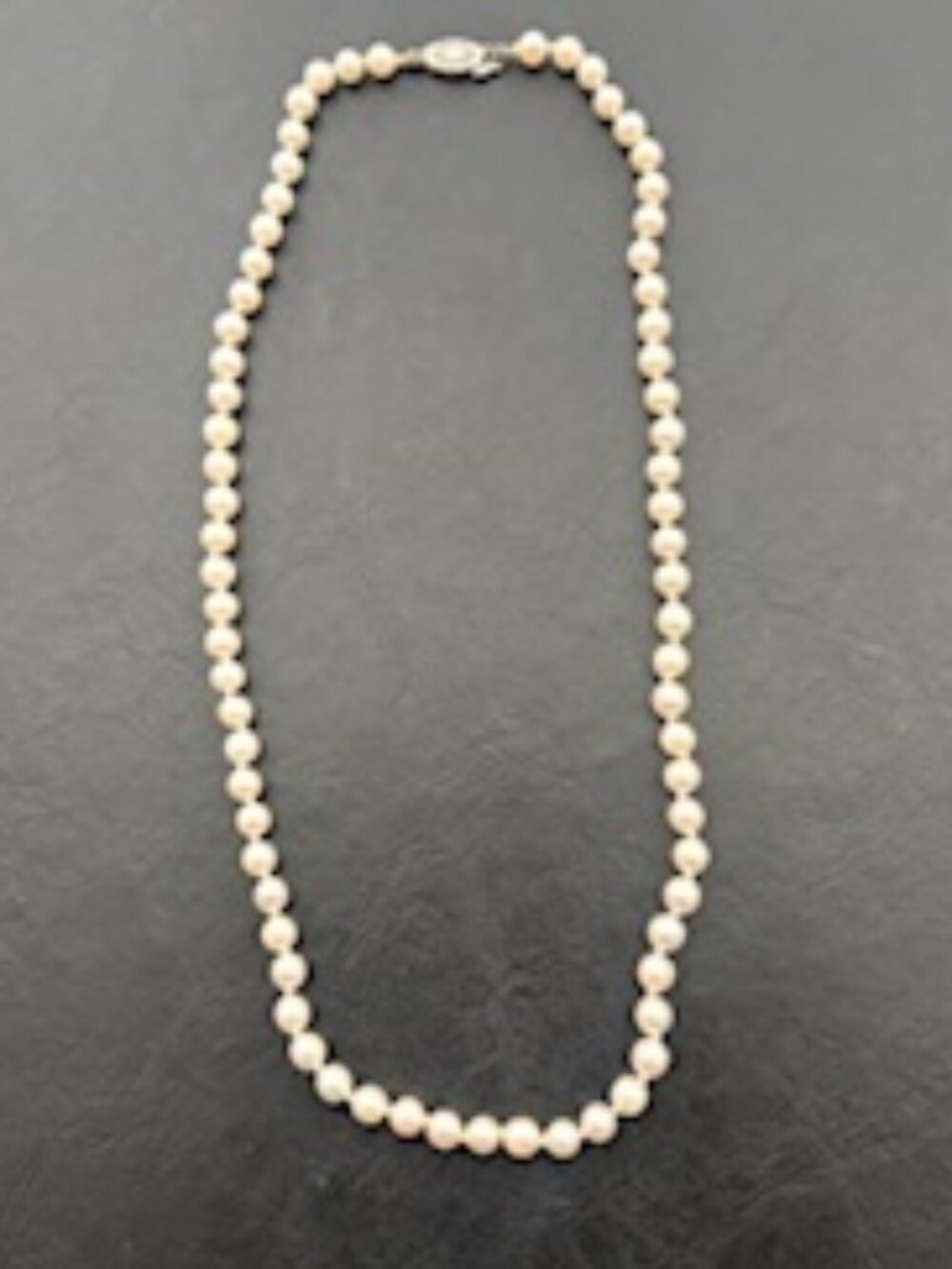 Beautiful classic strand of white pearls-Secured clasp